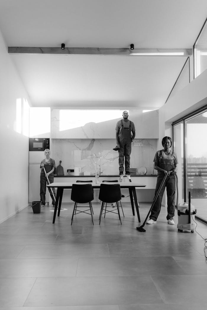 who-we-are Black and white photo of a cleaning crew in a modern home, showcasing teamwork.